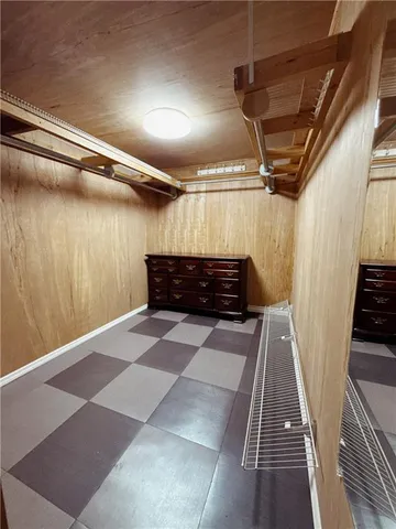 a view of walk in closet with wooden floor