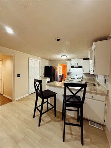 a view of a dining room with furniture and a potted plant