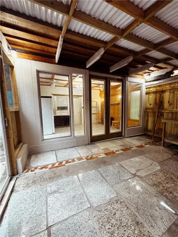a view of a room with wooden floor and windows