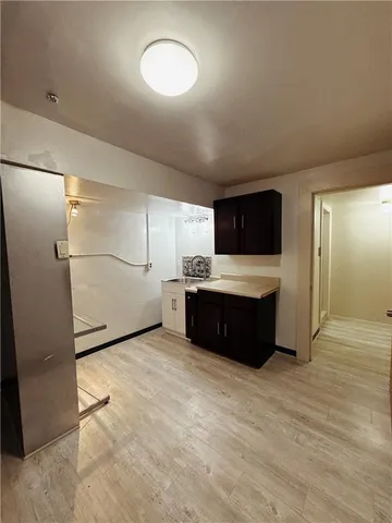 a kitchen with a refrigerator and a sink
