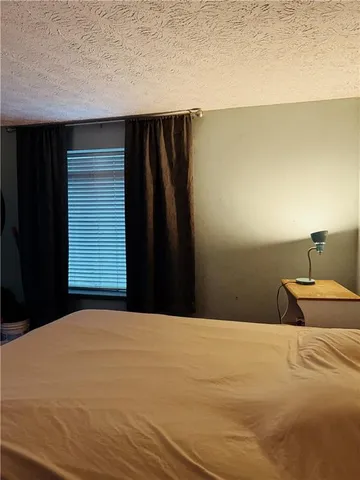 a bedroom with a bed and a night stand