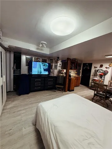 a large bedroom with a bed and a television in it