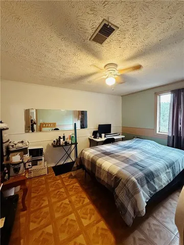 a bedroom with bed and a chandelier