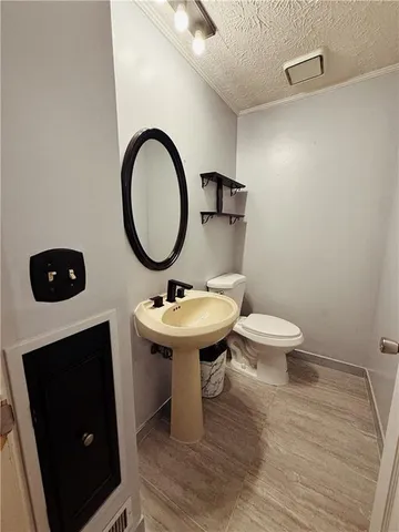 a bathroom with a toilet a sink and a mirror