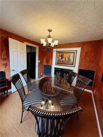 a living room with furniture a chandelier and a rug