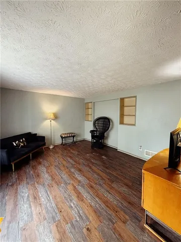 a bedroom with a bed and a tv on the dresser
