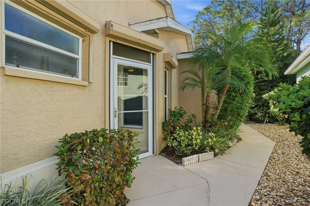10730 Rio Mar Circle Estero, FL 33928 - Photo 3 of 47 a couple of potted plants in front of door