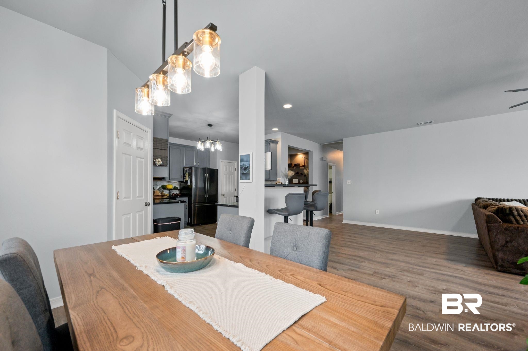 1287 Pembroke Way Foley, AL 36535 - Photo 14 of 39 Dining area featuring dark wood-style floors and a chandelier