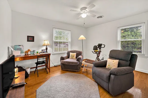 a living room with furniture a fireplace and a window