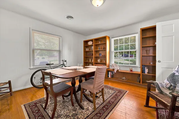 a dining room with furniture and window
