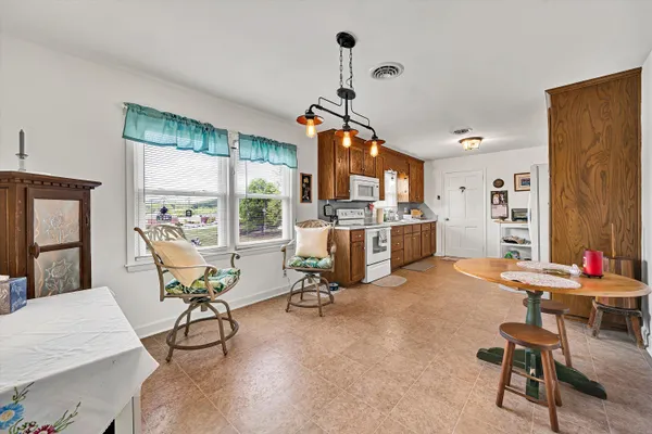 a living room with furniture a flat screen tv and a large window