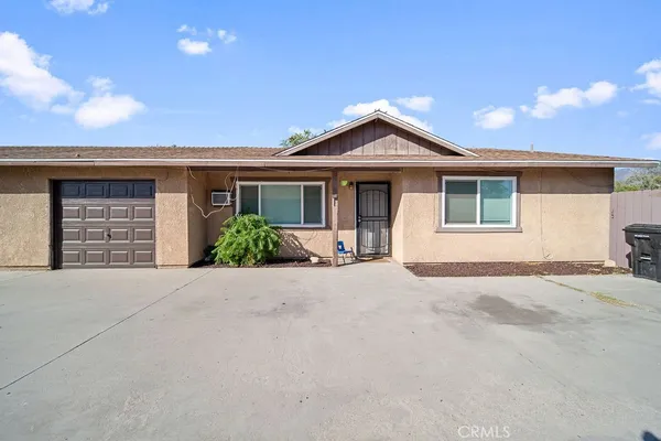 a view of house with yard and a garage
