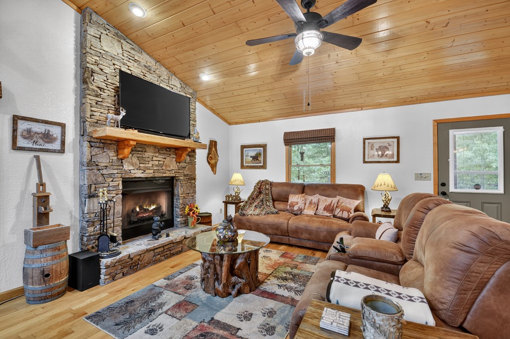 1044 Boulder Crk Road Murphy, NC 28906 - Photo 19 of 38 a living room with furniture a flat screen tv and a fireplace