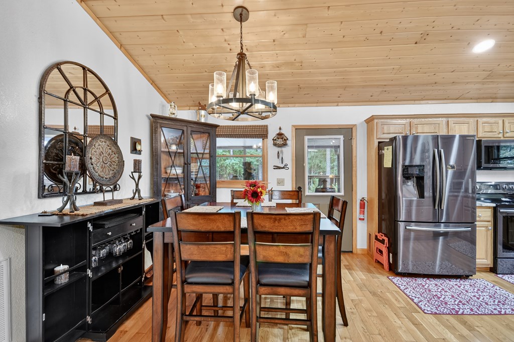 1044 Boulder Crk Road Murphy, NC 28906 - Photo 22 of 38 a dining room with furniture a chandelier and wooden floor