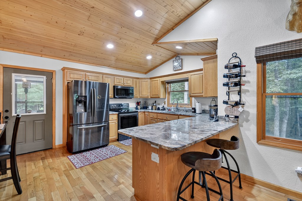 1044 Boulder Crk Road Murphy, NC 28906 - Photo 24 of 38 a kitchen with stainless steel appliances granite countertop a refrigerator and a stove top oven