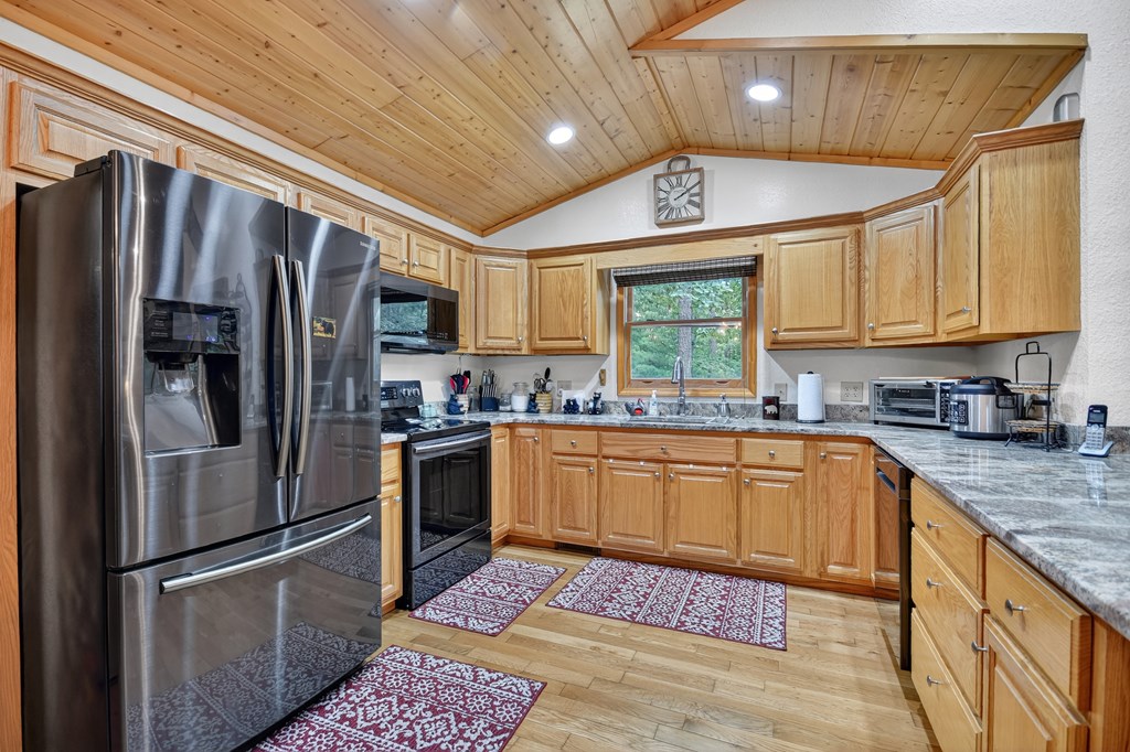 1044 Boulder Crk Road Murphy, NC 28906 - Photo 25 of 38 a kitchen with stainless steel appliances granite countertop a refrigerator stove and sink