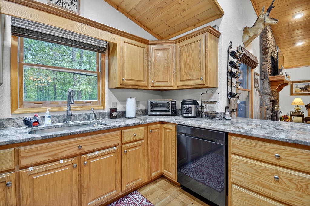 1044 Boulder Crk Road Murphy, NC 28906 - Photo 27 of 38 a kitchen with stainless steel appliances granite countertop a sink a stove and cabinets