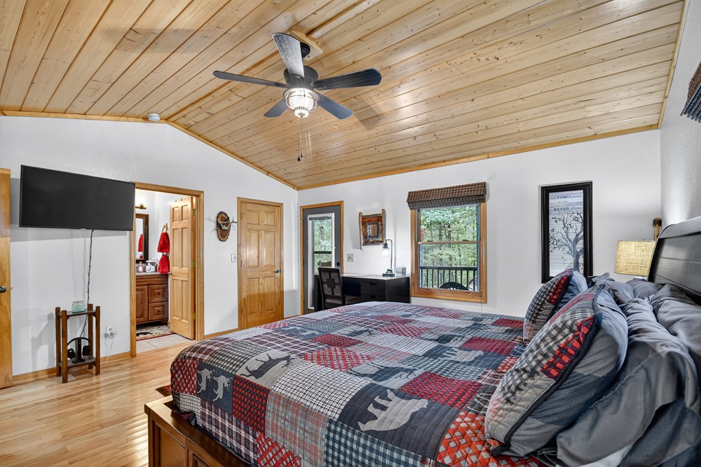 1044 Boulder Crk Road Murphy, NC 28906 - Photo 33 of 38 a bedroom with a bed and wooden floor