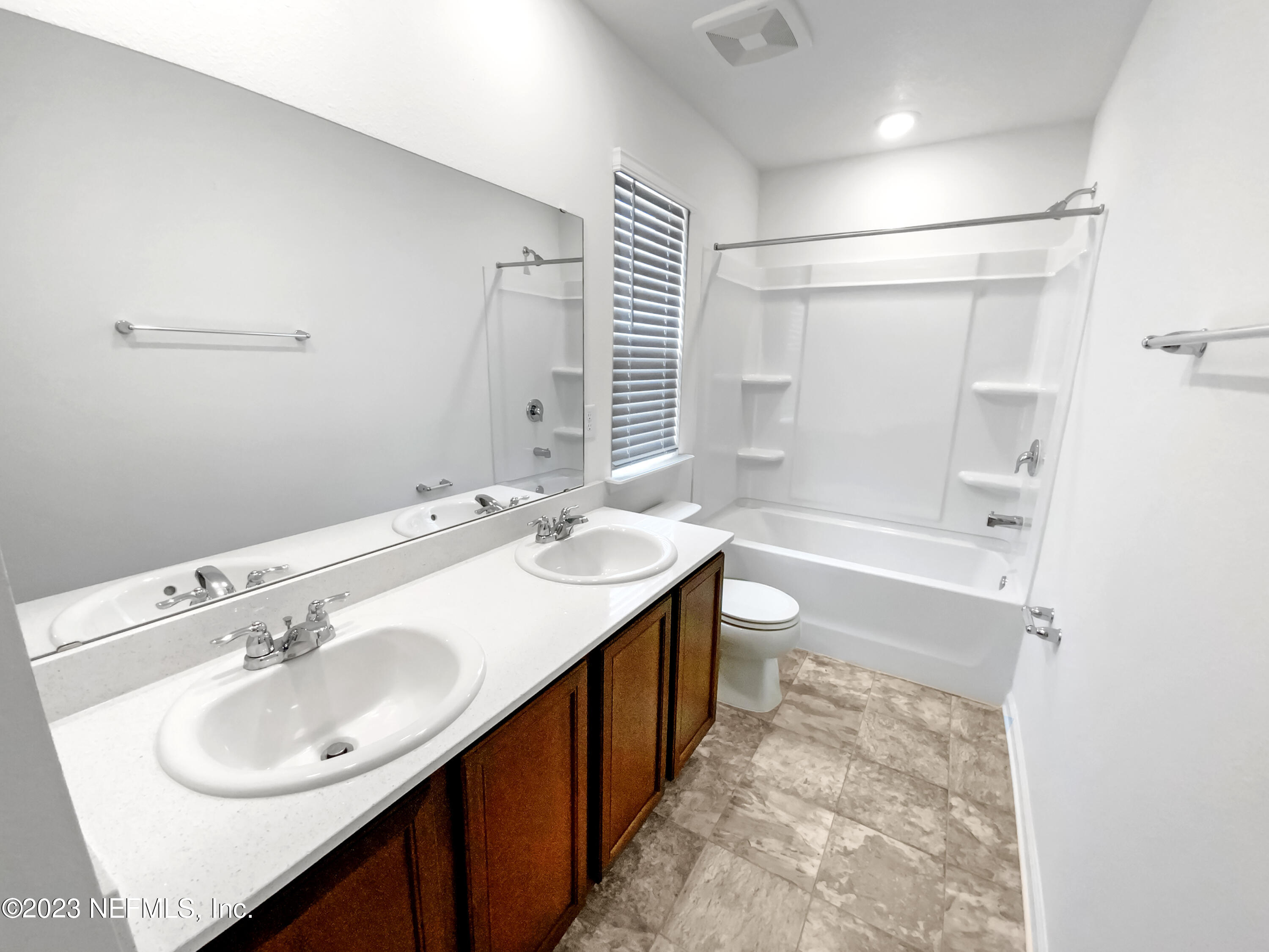 7909 Merchants Way Jacksonville, FL 32222 - Photo 17 of 19 a bathroom with a sink double vanity granite tub shower and a mirror