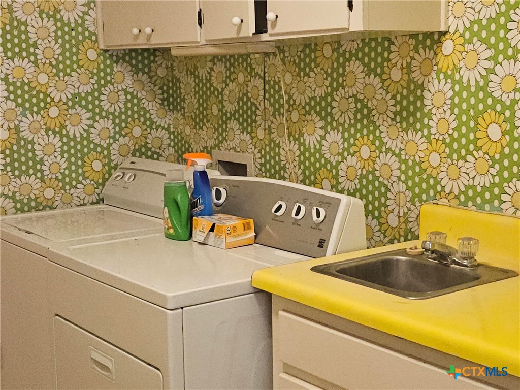 601 North Rhomberg Street Burnet, TX 78611 - Photo 19 of 42 a utility room with a sink and a washer dryer