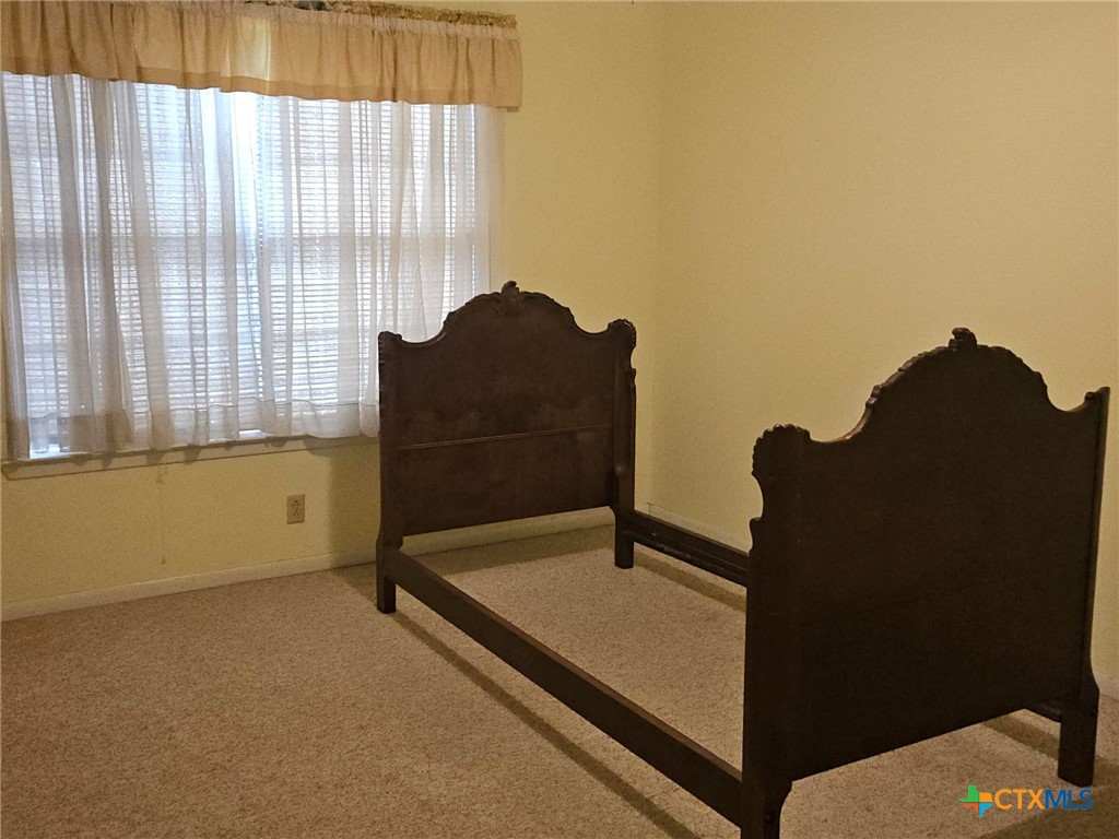 601 North Rhomberg Street Burnet, TX 78611 - Photo 25 of 42 a blue bed sitting in a room next to a window