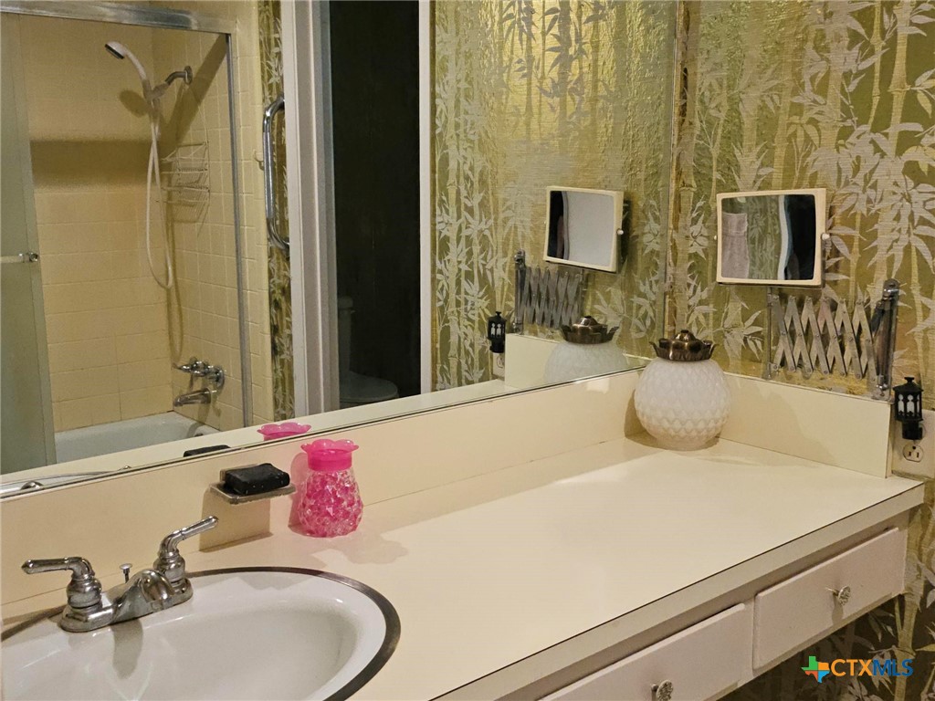 601 North Rhomberg Street Burnet, TX 78611 - Photo 26 of 42 a bathroom with a sink and a mirror