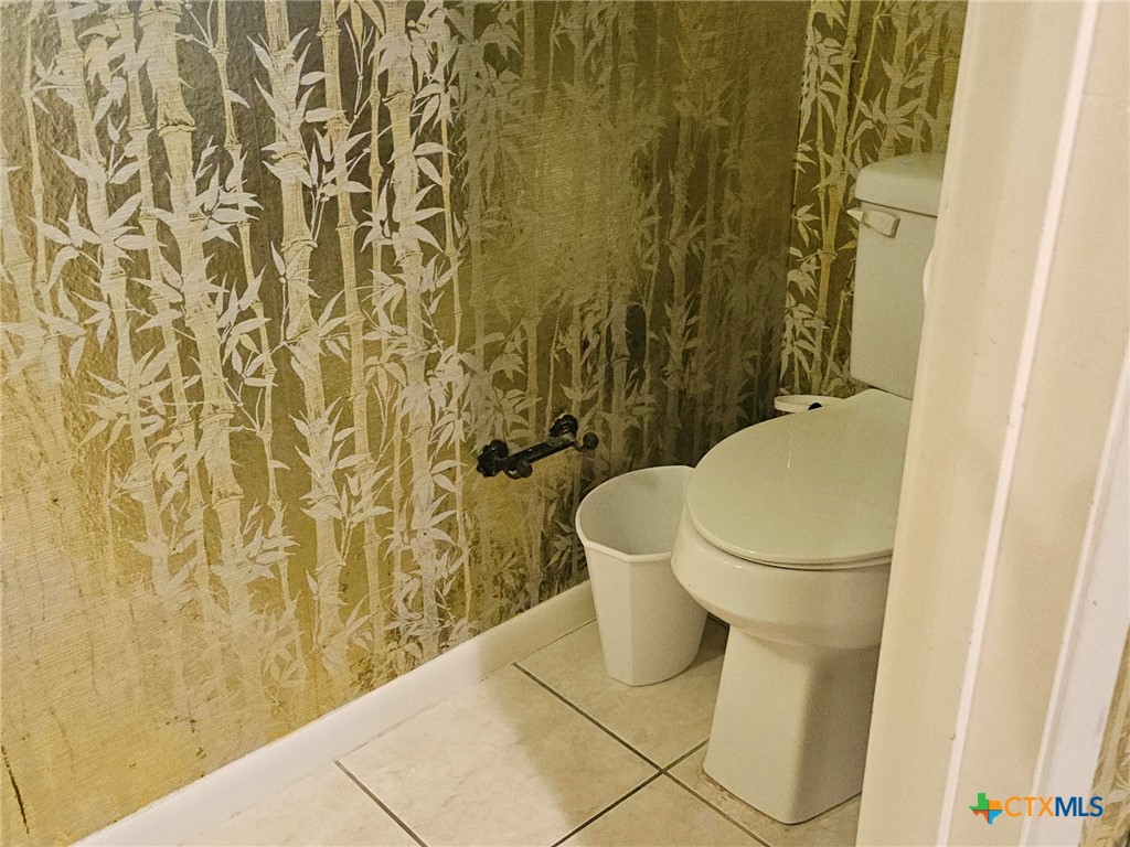 601 North Rhomberg Street Burnet, TX 78611 - Photo 27 of 42 a white toilet sitting next to a shower curtain