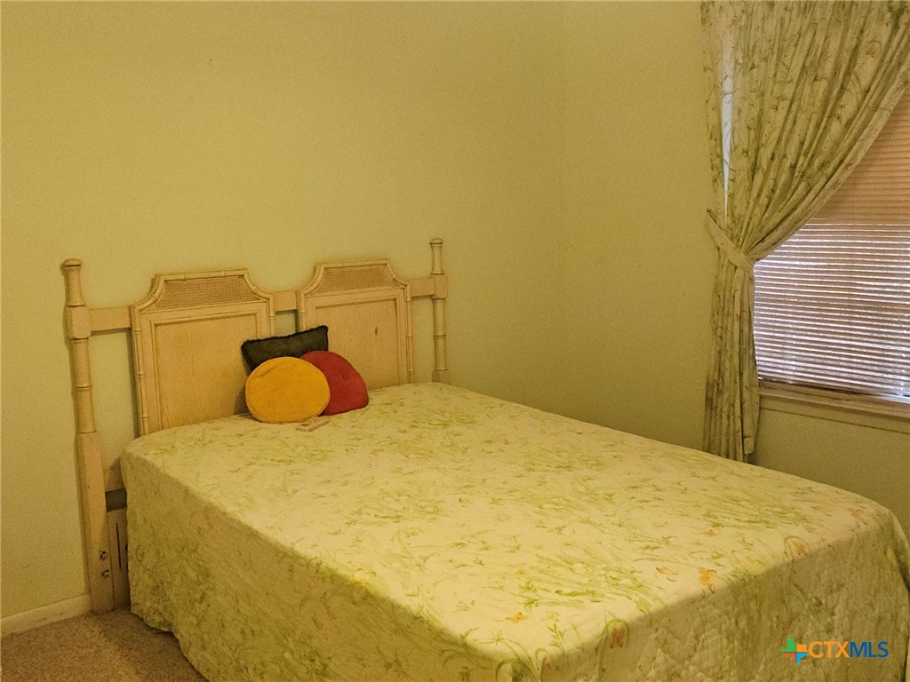 601 North Rhomberg Street Burnet, TX 78611 - Photo 29 of 42 a bedroom with a bed and wooden floor