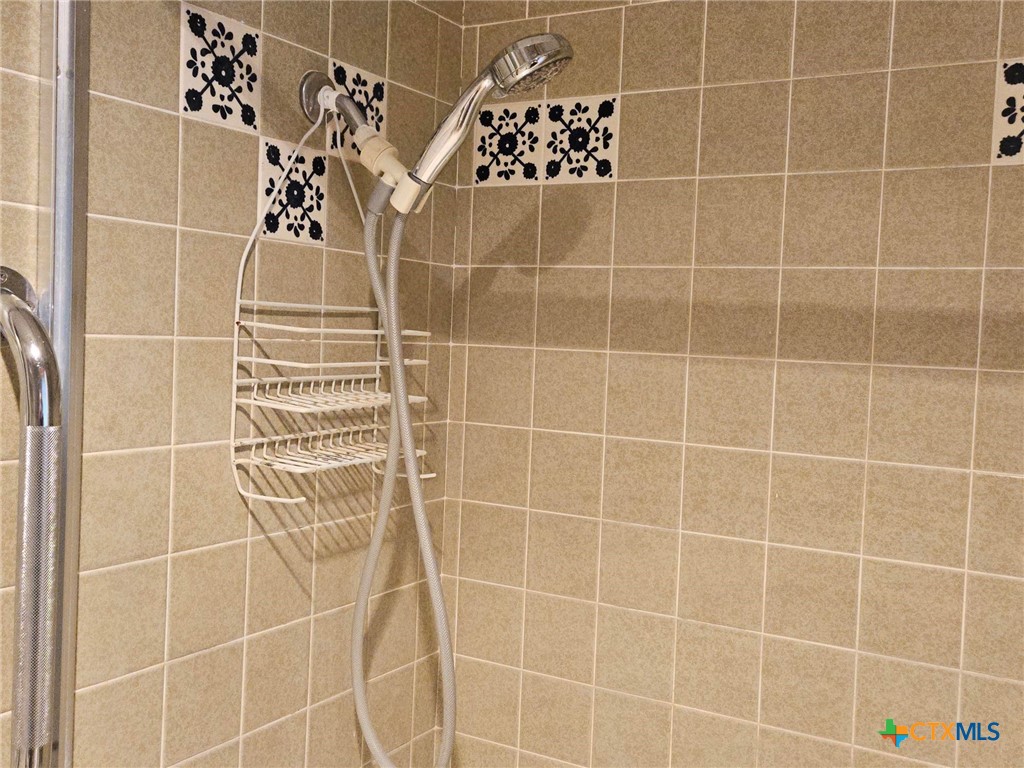 601 North Rhomberg Street Burnet, TX 78611 - Photo 32 of 42 a bathroom with a black white checkered floor