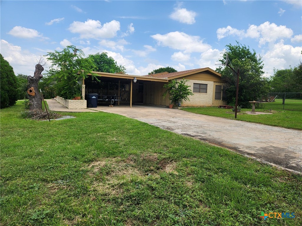 601 North Rhomberg Street Burnet, TX 78611 - Photo 5 of 42 a view of a house with a yard and a garden