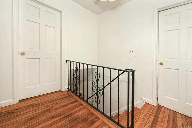 a view of a hallway with wooden floor and entryway