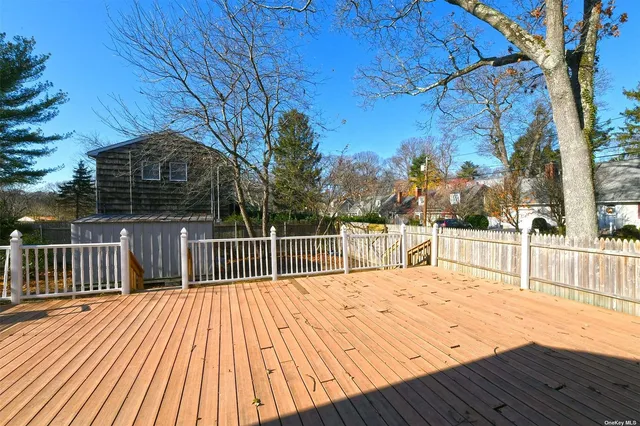 a balcony with wooden floor and fence