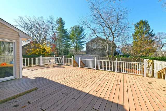 a view of backyard with a deck and wooden floor