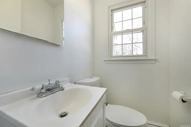 a bathroom with a sink mirror and toilet