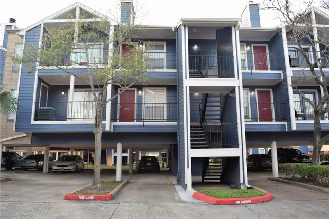 a kitchen with granite countertop white cabinets and sink
