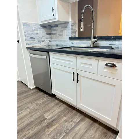 a kitchen with a stove and white cabinets
