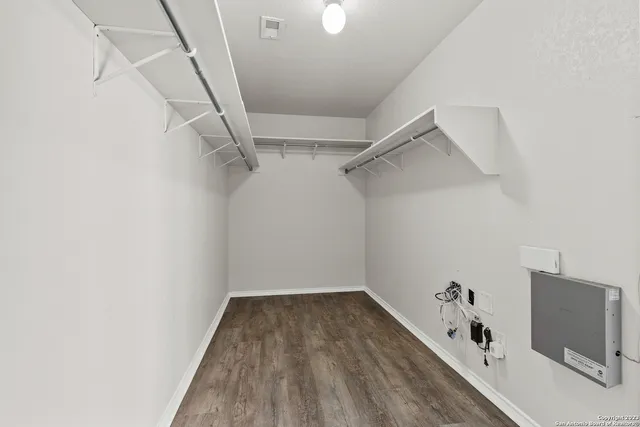 a view of a room with wooden floor