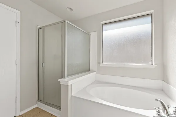 a white bath tub sitting next to a shower