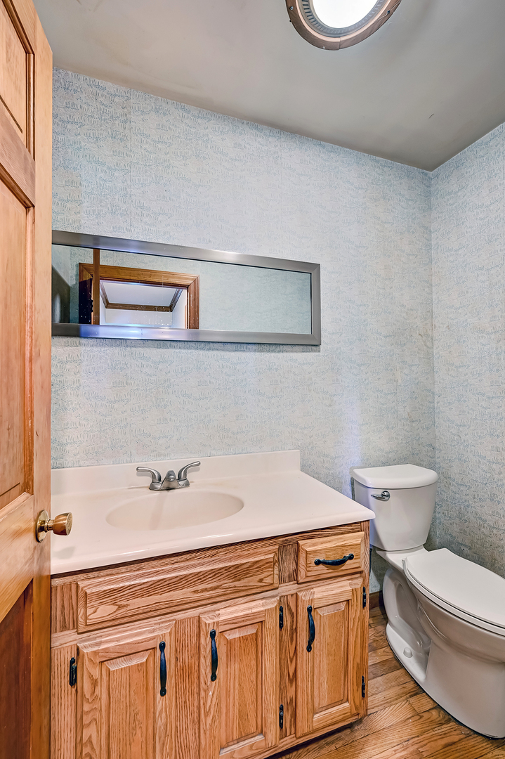 3007 Lincoln Road Oak Brook, IL 60523 - Photo 14 of 25 a bathroom with a sink a toilet and a mirror
