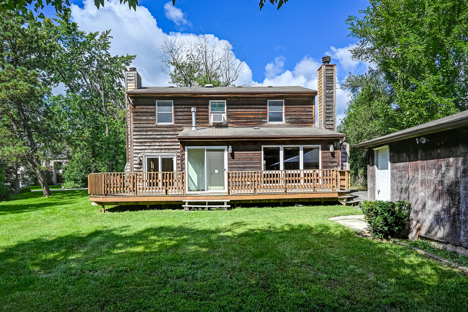 3007 Lincoln Road Oak Brook, IL 60523 - Photo 5 of 25 a front view of a house with a yard table and chairs