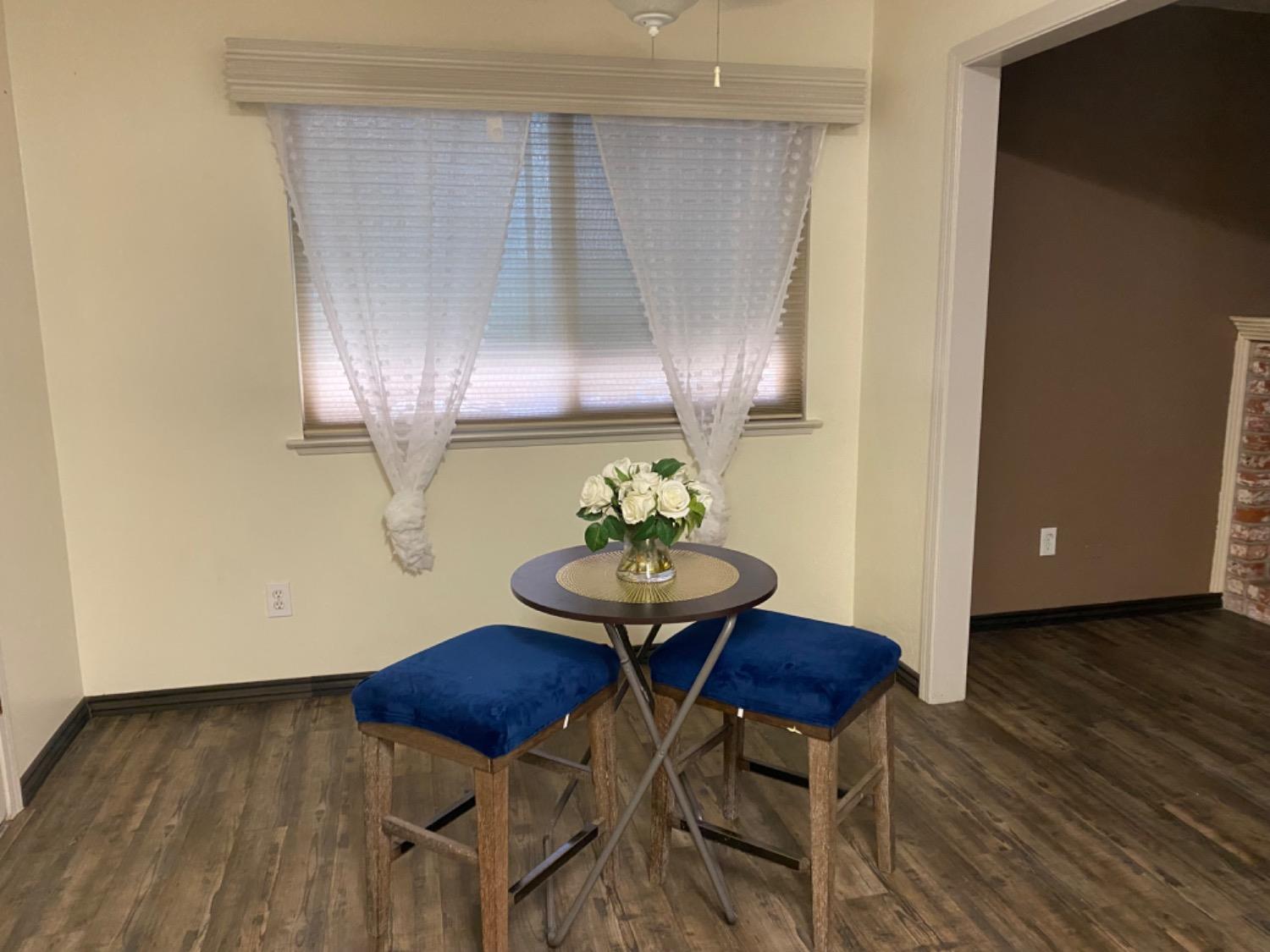 1712 Bundy Avenue Clovis, CA 93611 - Photo 2 of 9 a view of a dining room with furniture and wooden floor