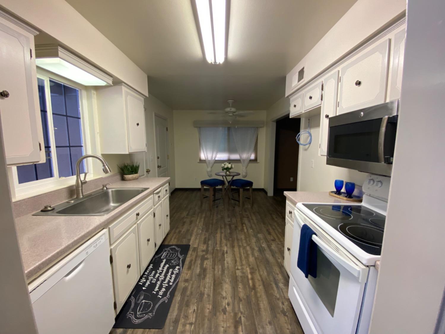 1712 Bundy Avenue Clovis, CA 93611 - Photo 3 of 9 a kitchen with sink a microwave and cabinets
