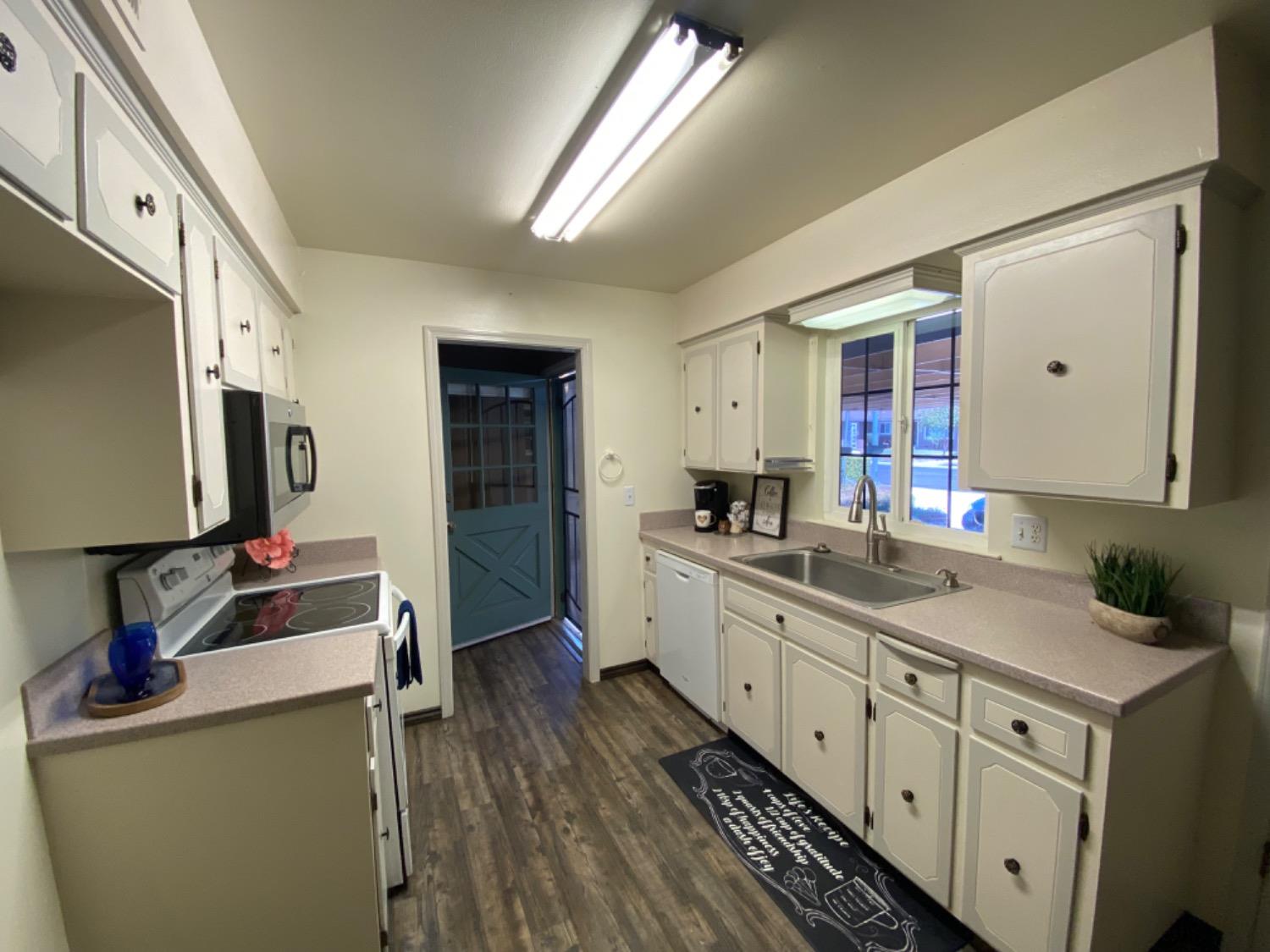 1712 Bundy Avenue Clovis, CA 93611 - Photo 4 of 9 a kitchen with cabinets a sink and appliances