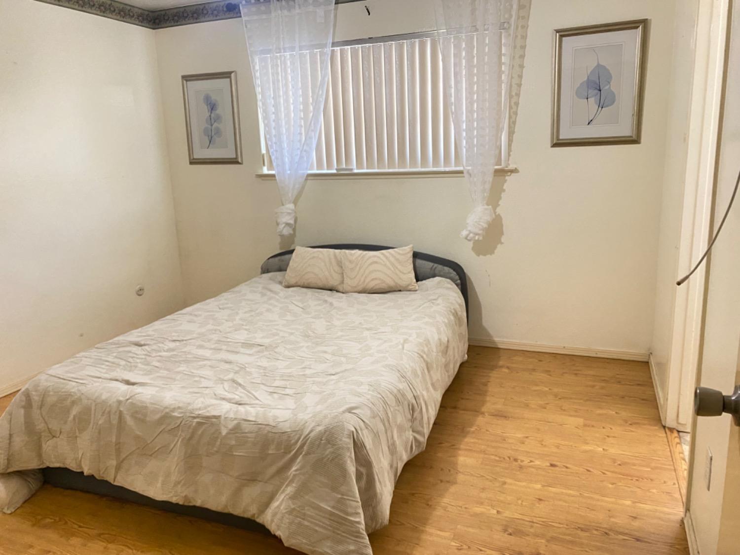 1712 Bundy Avenue Clovis, CA 93611 - Photo 5 of 9 a bedroom with a bed and a window