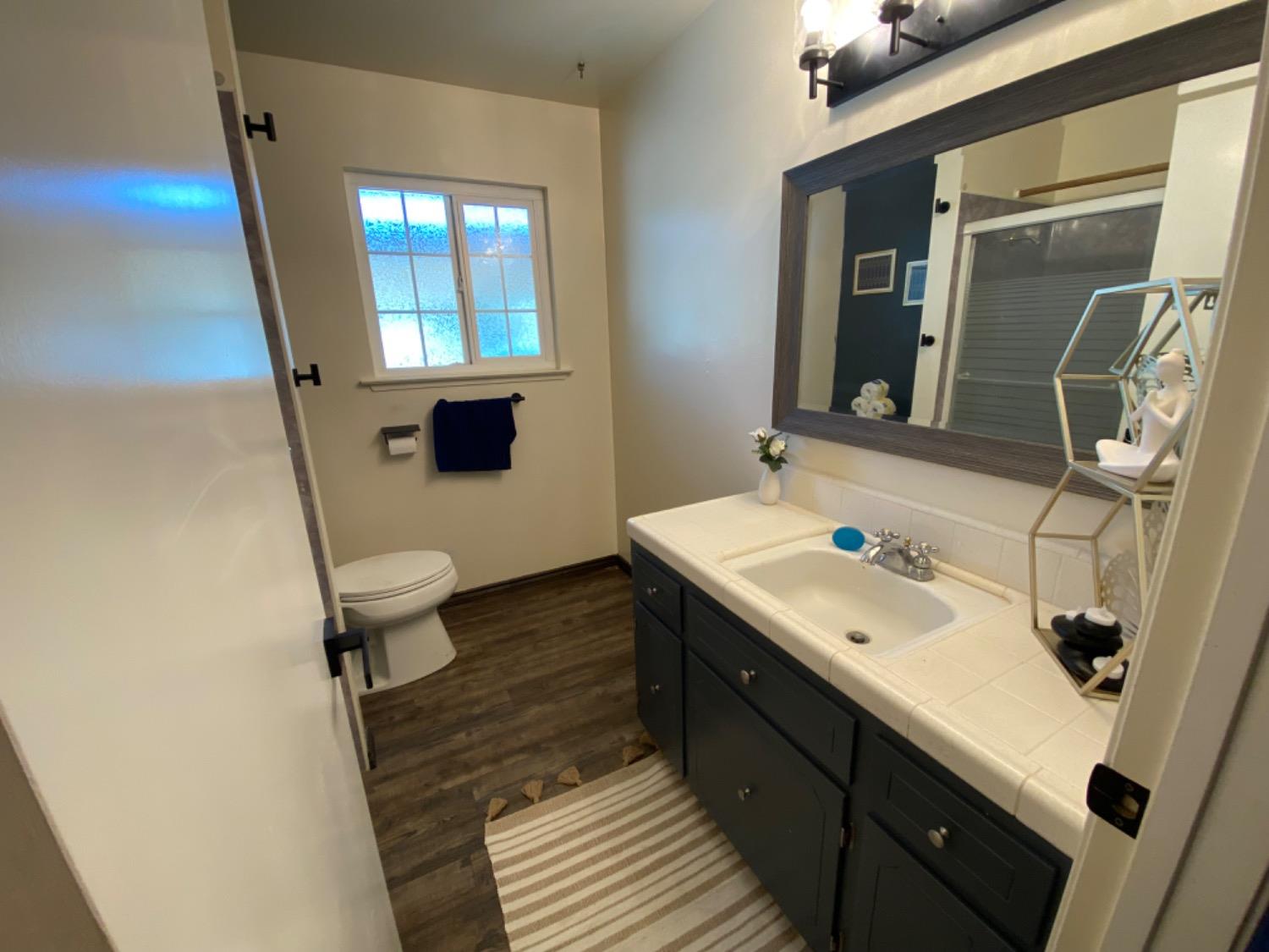 1712 Bundy Avenue Clovis, CA 93611 - Photo 7 of 9 a bathroom with a sink toilet and mirror