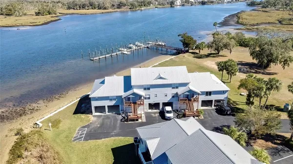 an aerial view of a house with a lake view