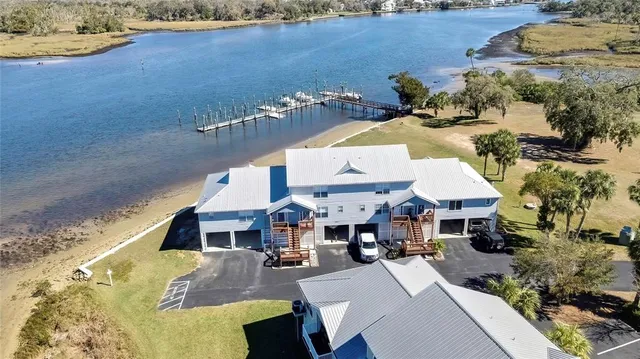 an aerial view of a house with a lake view