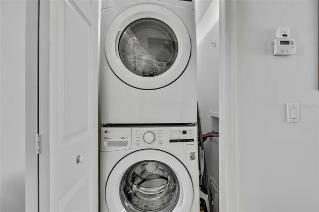 a bathroom with a granite countertop sink vanity mirror and toilet