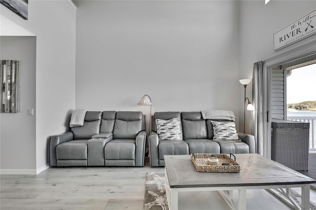 2855 North Rivers Edge Boulevard, Unit 213 Crystal River, FL 34429 - Photo 18 of 62 a living room with furniture and wooden floor