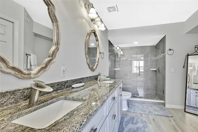 a bathroom with a toilet sink and shower